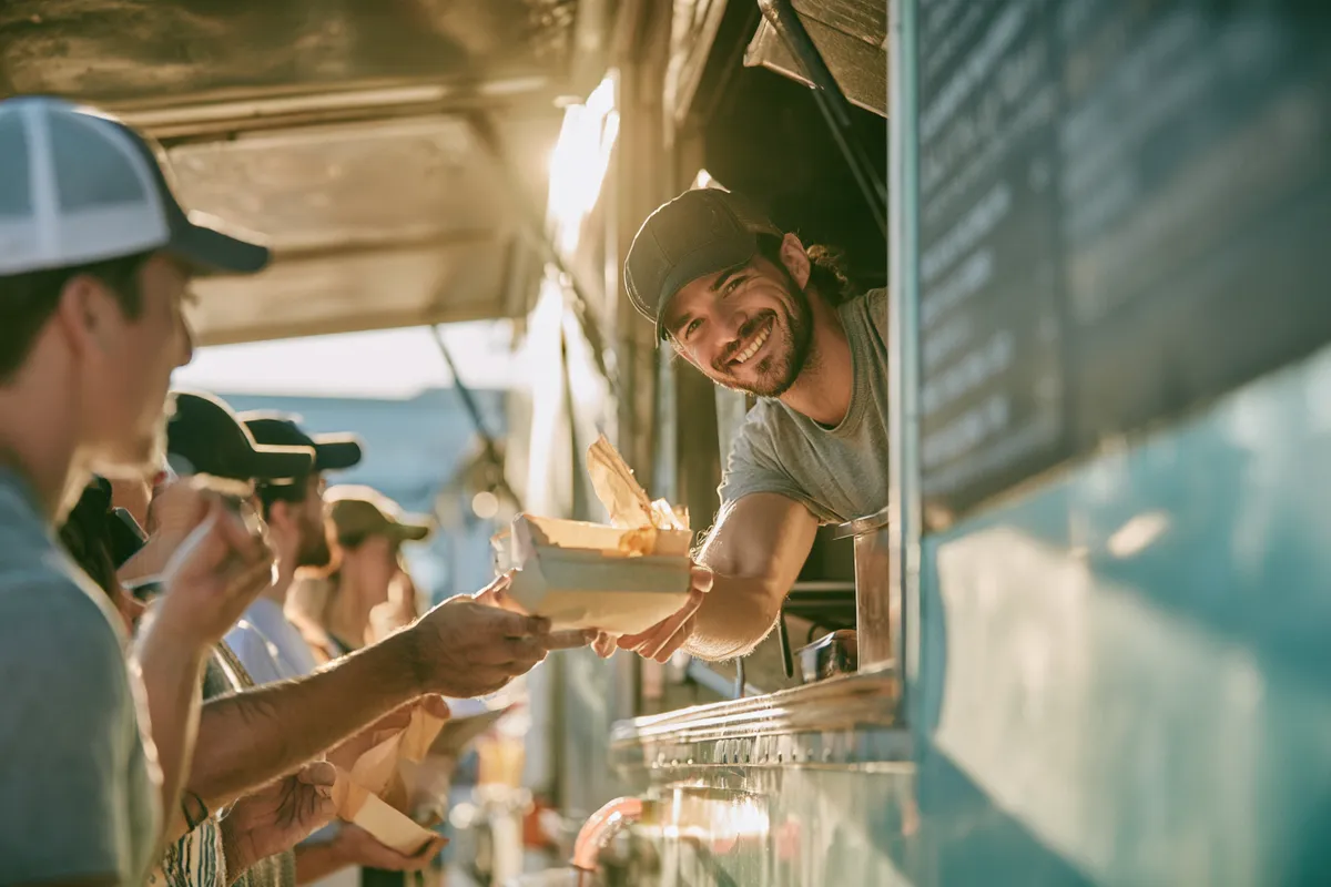 Food truck owner serving the lunch rush — $2,000 covers the repairs and gaps that keep a working life moving